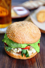 Big tasty hamburger on dark wooden background, close up