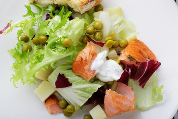 salad with slice of roasted salmon