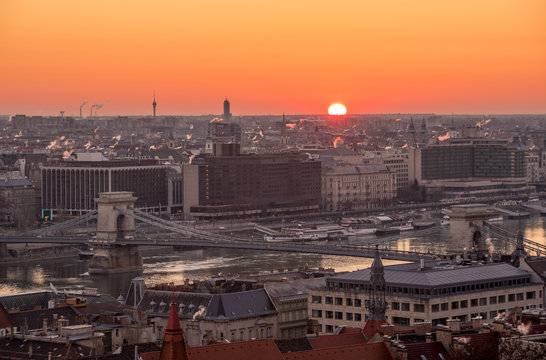Rising Sun over Cityscape of Budapest with Chain Bridge over Danube River
