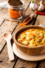 lentil soup in a wooden bowl