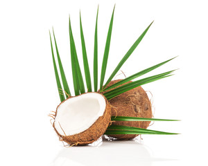 Fototapeta na wymiar Coconut with green leaves on white background
