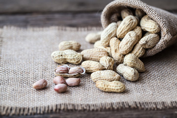 Peanut in sacks on the wooden background