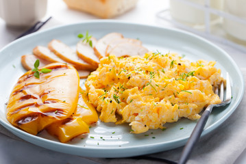 Eggs Scrambled, omelet with grilled bell sweet pepper and hot smocked chicken, ham in a plate on a white background