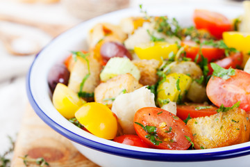 Traditional healthy Panzanella salad with fresh tomatoes and crispy bread