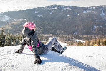 Fototapeta na wymiar Girl skier lying on snow without ski, High mountain