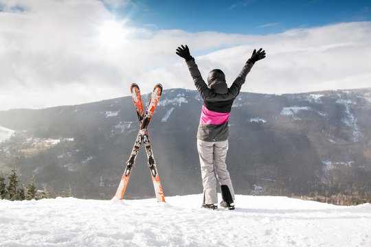 Happy woman skier in mountains with ski, High mountain