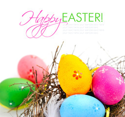 Colorful easter eggs in nest on a white background