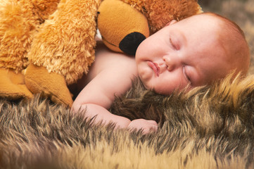Amazing sweet baby sleeping with teddybear