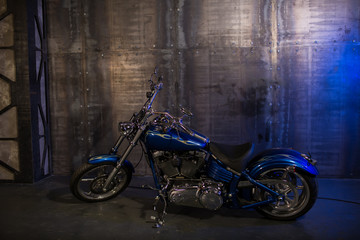 Fototapeta na wymiar beautiful blue motorcycle on the background of vintage wall