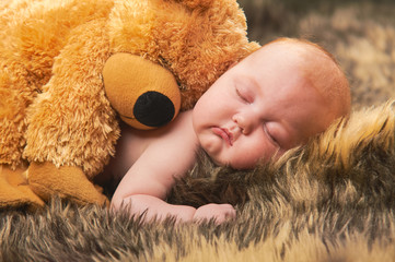 Amazing sweet baby sleeping with teddybear