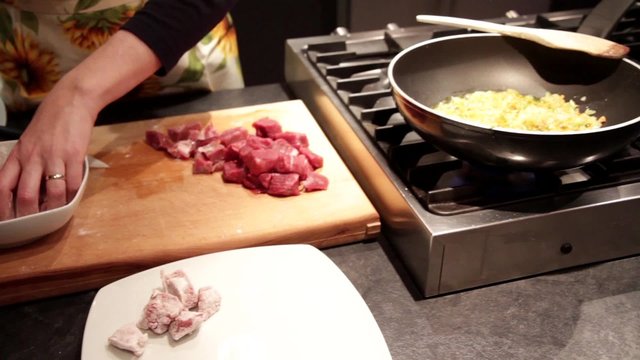 Stew meat preparation with potatoes and carrots, cut and flouring