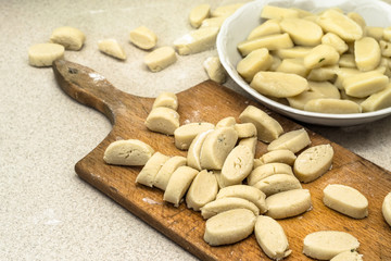 Raw potato dumplings prepared for cooking.
