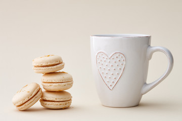 French macarons and a cup with heart