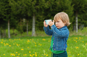 Little kid taking a selfie with cell phone