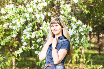 Fototapeta premium Young spring woman in blooming tree
