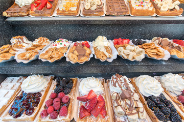 Vary of decoration on pancake with fruits, berries, chocolate, fudge, etc