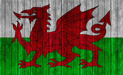 Wales Flag on old wood texture background
