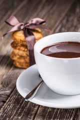 Hot chocolate with homemade oat cookies in satin ribbon.