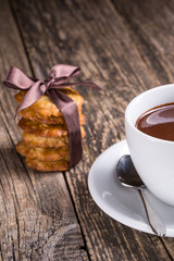 Hot chocolate with homemade oat cookies in satin ribbon.