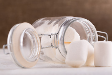 Marshmallows spilling from a storage jar.