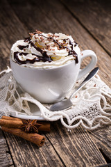 Cup of hot cappuccino with cinnamon for breakfast.
