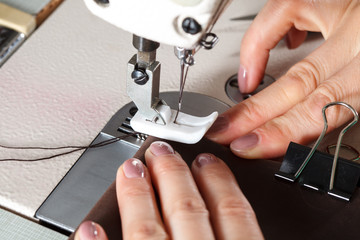Sewing machine with womans hands