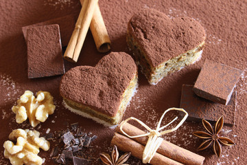 Chocolate, cocoa powder, cinnamon stick, walnut and cake hearts
