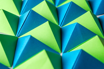 Abstract background with blue, green and yellow origami tetrahedrons is great for using in web.