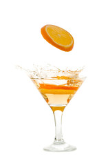 orange slice falling into the cocktail