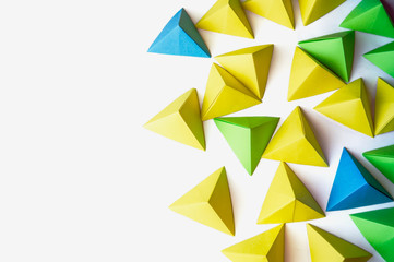 Origami pyramids background. Futuristic polygonal composition with copy space on the left side.