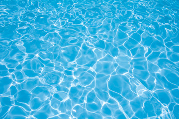 Fototapeta na wymiar Beautiful gentle wave in swimming pool with sun reflection