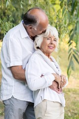 Obraz premium Senior couple embracing and kissing