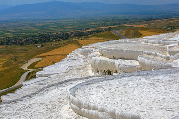 white Pamukkale terraces against rural landscape