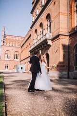 two couple after wedding in tne park near the castle