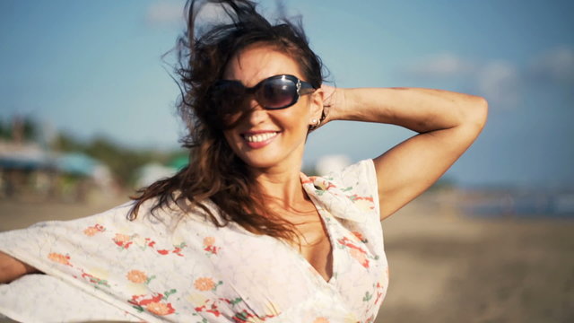 Young, happy woman enjoying sunny day on beach
