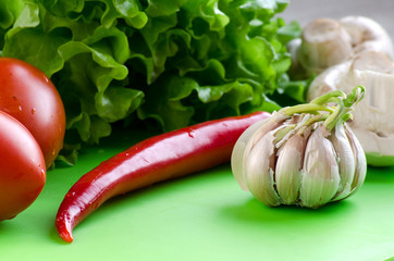 Vegetables, garlic, and mushrooms on the kitchen blackboard