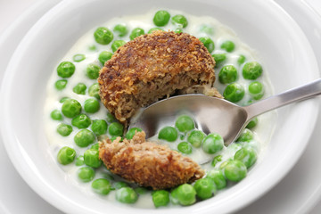 green peas fozelek (thich vegetable stew) and fasirt (fried meatball), hungarian cuisine