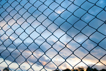 Fototapeta premium Steel Wire mesh and cloud in Evening Sky background