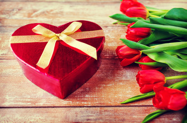 close up of red tulips and chocolate box