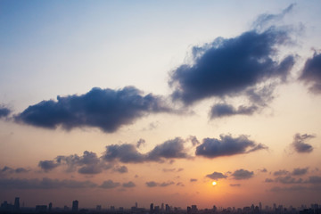 Sunset sky with clouds and sun