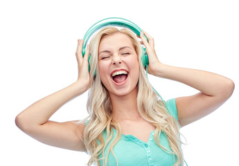 happy young woman or teenage girl with headphones