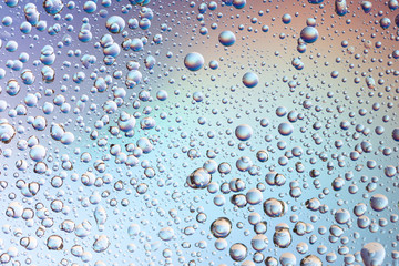 close-up of water drops on gradient color background. bubbles abstract background