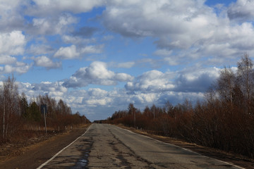 Autumn road and sky with clouds