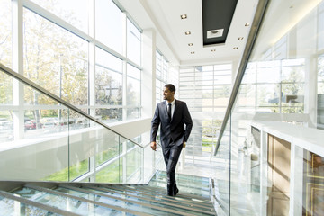 Modern black businessman on the stairs