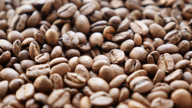 Background of Arabic type coffee beans on table slow tilt 4K 2160p 30fps UHD video - High quality coffee beans of Arabica type 4K 3840X2160 UltraHD footage 