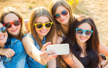 Friends in sunglasses taking selfie