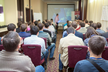 The audience listens to the acting in a conference hall