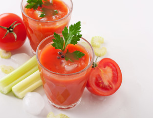 glass of fresh tomato juice on white background