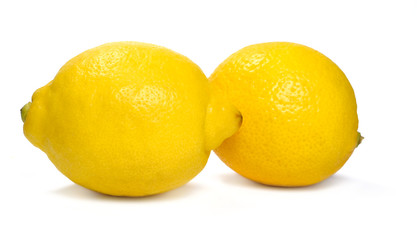 Two fresh whole lemons, isolated on white background.