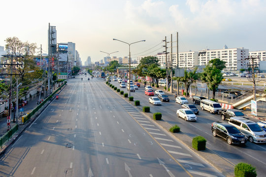 Traffic moves slowly along a busy road in Bangkok, Thailand.